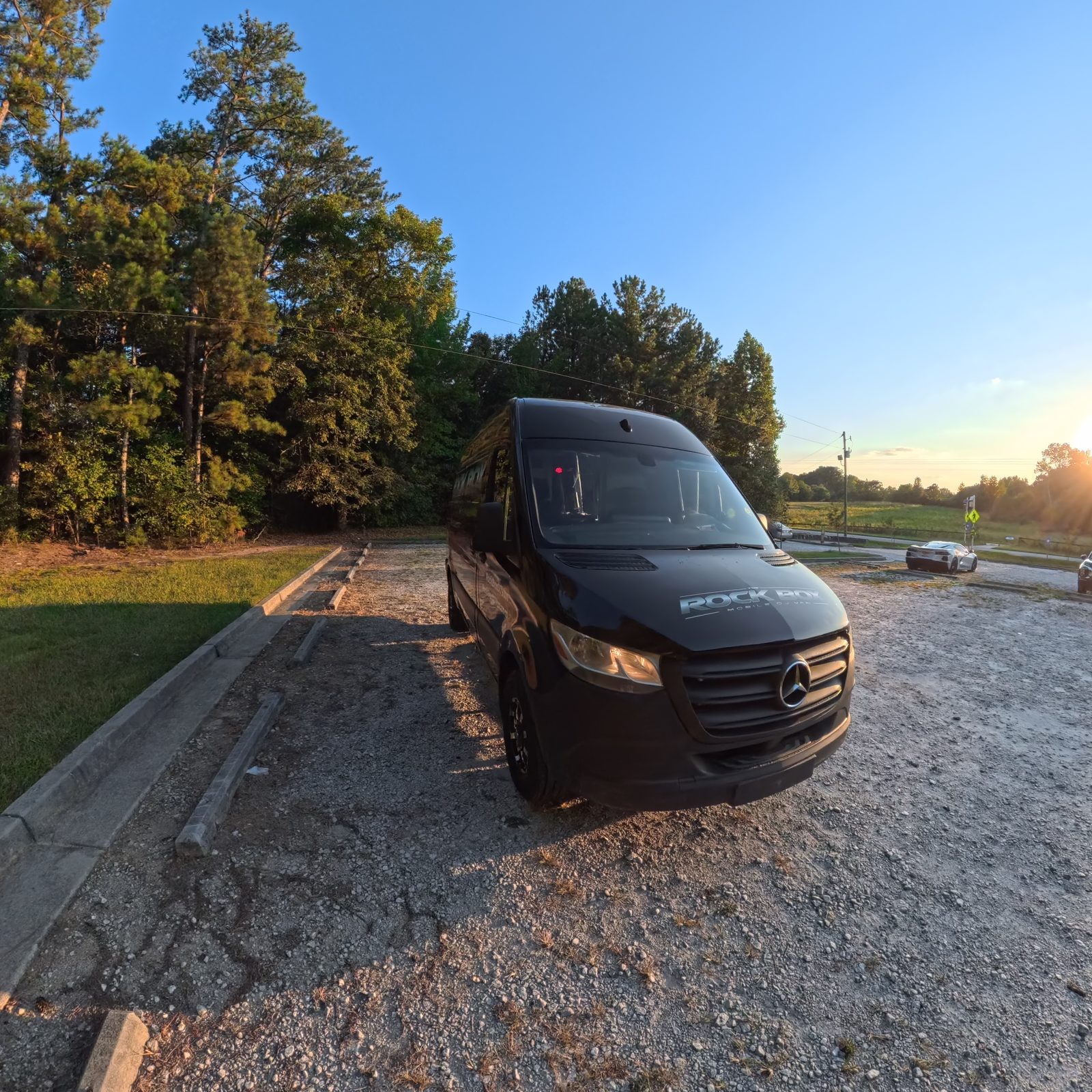 The Rock Box mobile DJ van parked outdoors at sunset